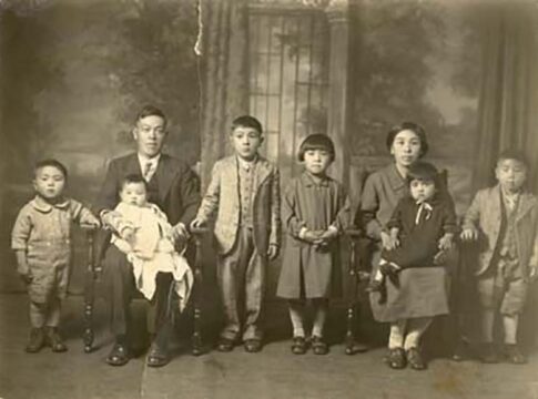 Family of eight poses in studio for portrait.