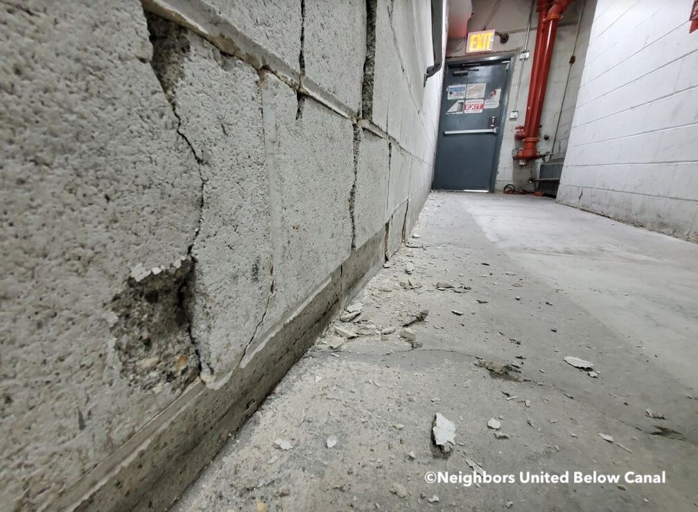 Cracks are being seen in the concrete at a building next to the demolition for a new jail in Manhattan Chinatown.