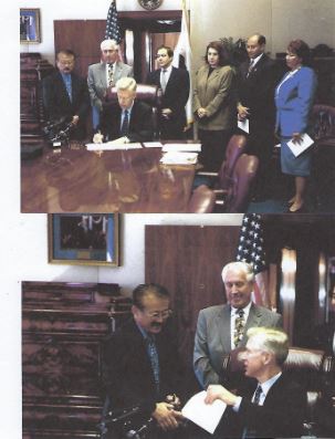 Assem. George Nakano at a bill signing with Governor Grey Davis. The governor signs a bill authorizing $1 million for the Japanese American National Museum in 1999.