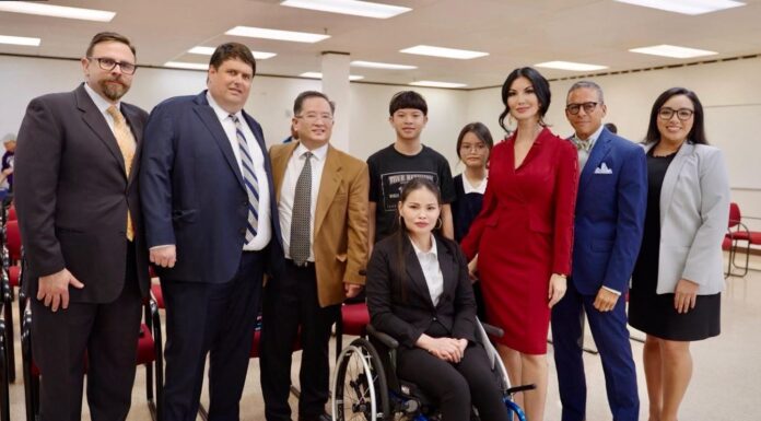 Nhung Truong (in the wheelchair) poses with her family and her attorneys