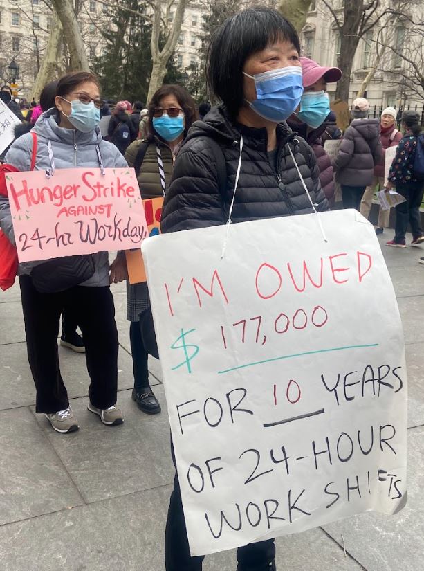 Home care workers picket in front of City Hall during the rally kicking off their hunger strike against the 24-hour workday.