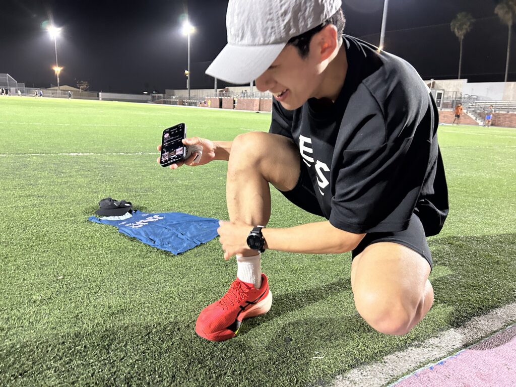 South Korean athlete and Eighty Eight Seoul run club member Won Hyeong-seok, who also goes by Stone, laughing as he dusts the beads of fake turf off of his shin at the end of his visit with the Koreatown Run Club in Los Angeles. Photo by Jia H. Jung