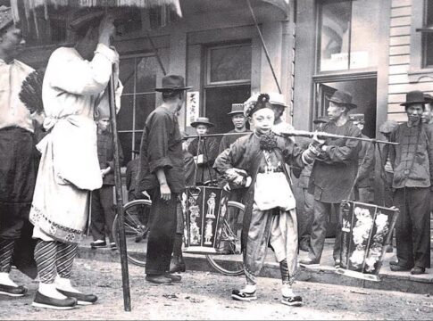 Chinatown in Astoria, Oregon with Chinese festival participants, 1890s.