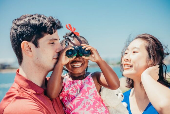 Asian female is seen holding a child with a White man