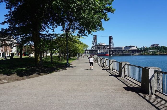 A jogger enjoys Tom McCall Waterfront Park in Portland, OR
