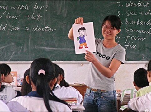 Teacher speaks to a classroom of Asian students