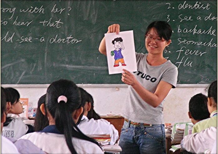 Teacher speaks to a classroom of Asian students