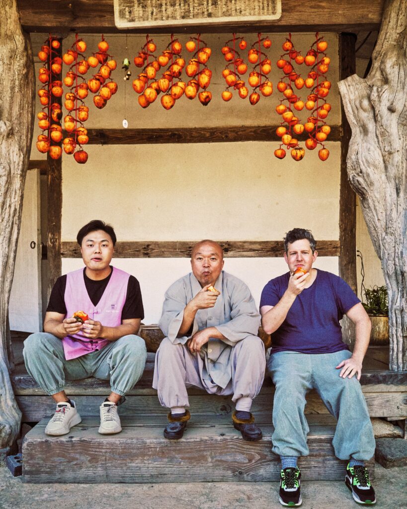 Deuki Hong Matt Rodbard Koreaworld An image of the authors enjoying persimmons in South Korea. Courtesy of Koreaworld