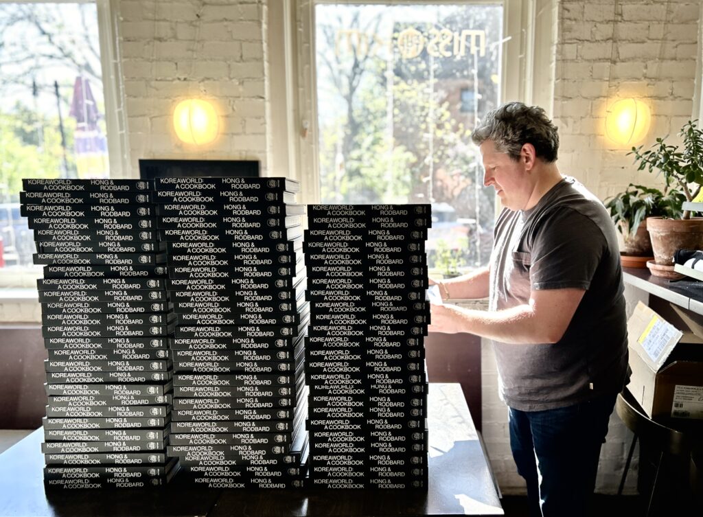 Matt Rodbard signing copies of Koreaworld at a special book tour at Miss Kim in Ann Arbor on April 30. Photo by Jia H. Jung