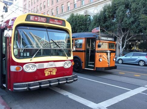 2 San Francisco public transit buses on a city street
