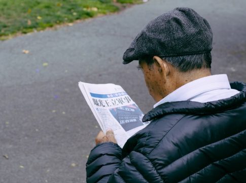 Asian senior reading a newspaper