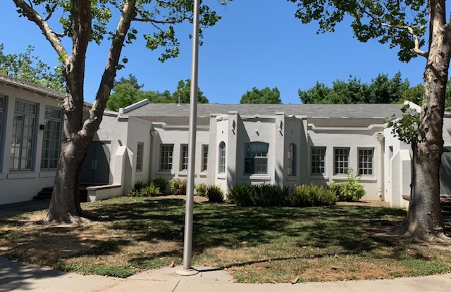 School house with flag pole.