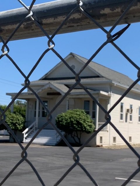 Church behind a chain link fence.