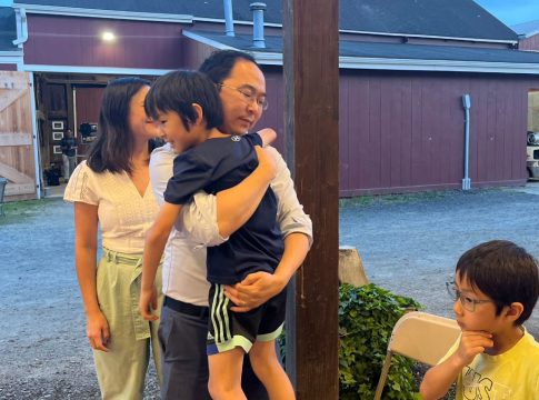 Andy Kim hugs his son after learning he won the primary for U.S. Senate in New Jersey