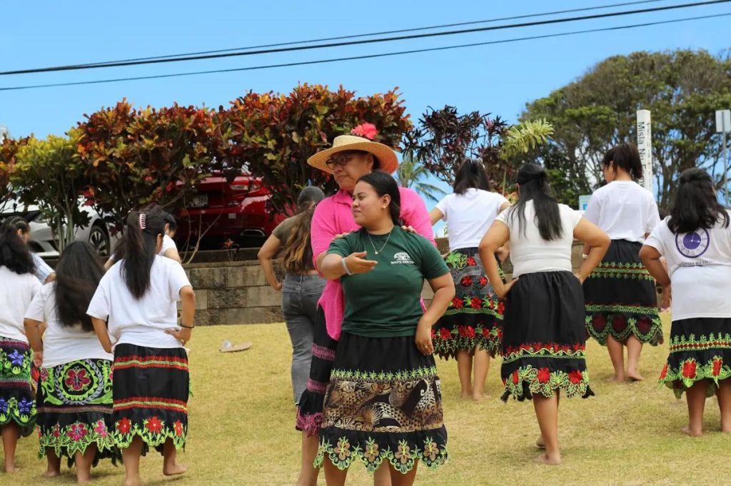 Anndionne Selestin, wearing green, performs with traditional dance group Kaunopada Maui Youth. 