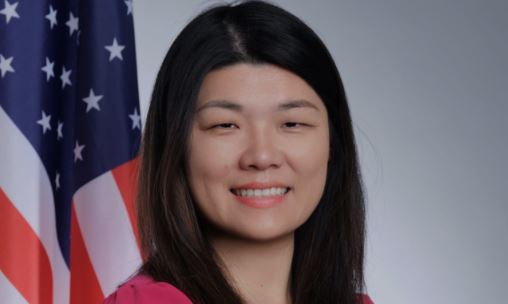 New York Councilwoman Susan Zhuang poses in front of the American flag