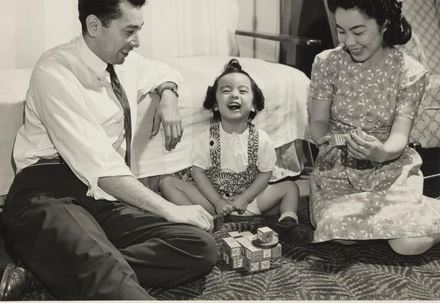 From the WRA: “Shown in their apartment in Kansas City, Missouri, are May and Tats Kushida,
with their daughter, Pamela, age 2-1/2. Employed as a Junior Relocation Officer, Tats has been with the
Central Area staff of the WRA since January, 1944. They relocated from the Poston, Arizona, Relocation
Center, to which the Kushidas were evacuated from Los Angeles. May is formerly of Sacramento, while
Tats claims Berkeley, California, as his home town. Both are graduates of the University of California.
Pamela is one of over a dozen pre-school Sansei children in Kansas City. Photographer: Iwasaki, Hikaru
Kansas City, Missouri.
Courtesy: WRA Photo Collection, UC Berkeley, Bancroft Library