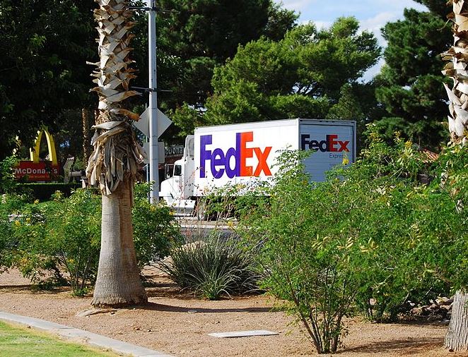 A Federal Express truck is seen driving down a street