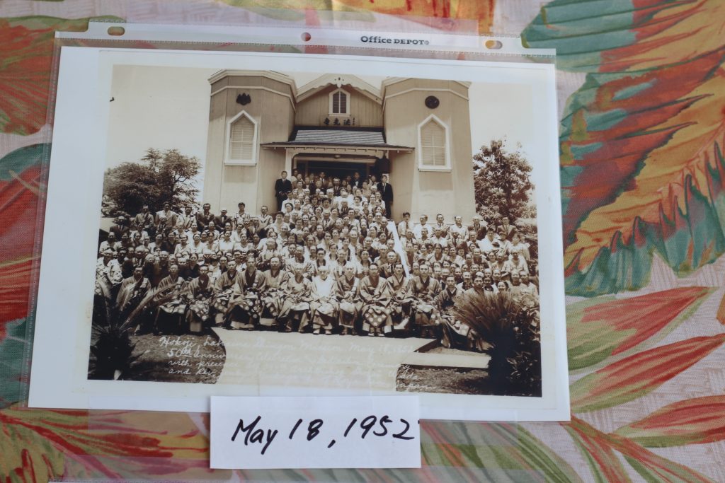 A picture of temple members posing in front of their temple in the 1950's.