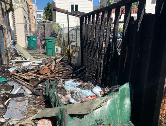 Debris from the fire sits amidst the charred ruins.