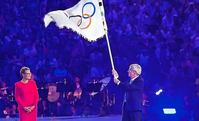 International Olympic Committee President Thomas Bach hands over the Olympic flag to Los Angeles Mayor Karen Bass, symbolizing the transitioning from the 2024 Paris Games to the 2028 Los Angeles Games.