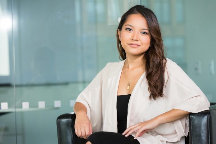 AANHPI woman in business casual attire sitting