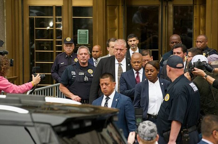 Eric Adams walks to his car after exiting the courthouse where he pled not guilty to bribery and conspiracy charges