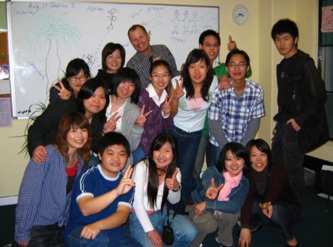 Asian American students pose with their teacher