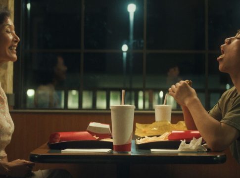 Izaac Wang as the son sits across from Joan Chen as the mother in Didi. They enjoy a milkshake at a local restaurant and Izaac leaves his mouth wide open in a light-hearted moment