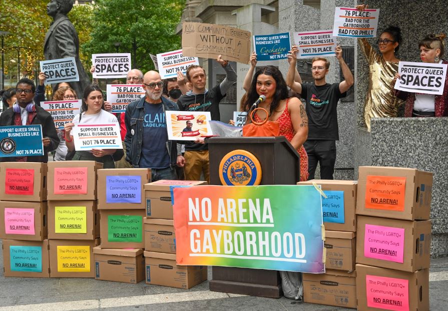 Protestors hold up signs declaring the proposed 76er arena is bad for Gayborhood