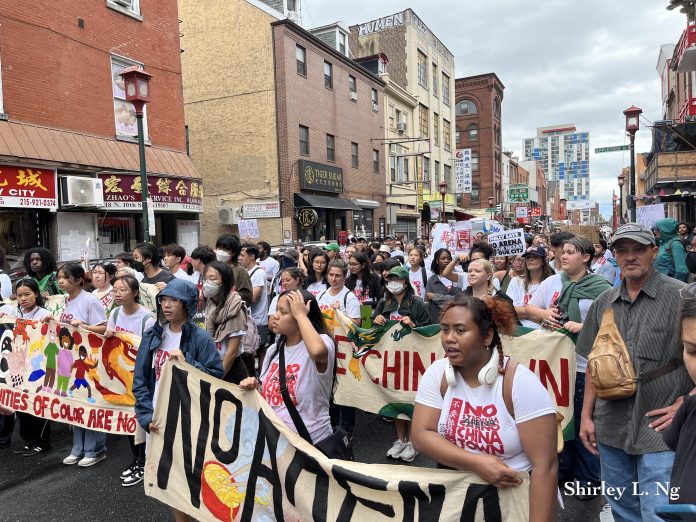 Supporters of Philadelphia Chinatown march from City Hall to Chinatown.