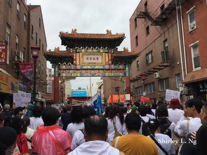 After the rally at City Hall, the community marched to the Chinatown arch. Photo by: Shirley L. Ng