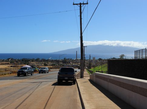 A photo of Lahaina's streets framed by the ocean and mountains in the background.