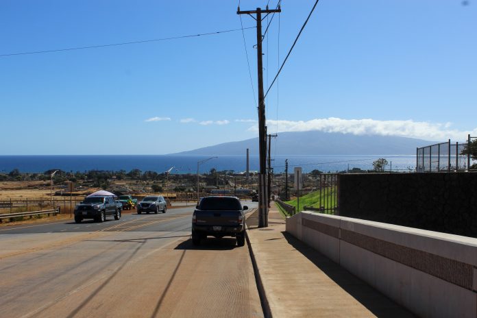 A photo of Lahaina's streets framed by the ocean and mountains in the background.