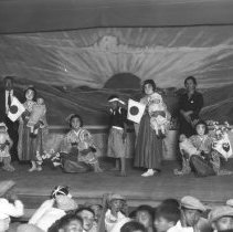 Children on a stage performing a play.