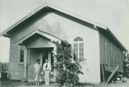 Man and woman in front of church.