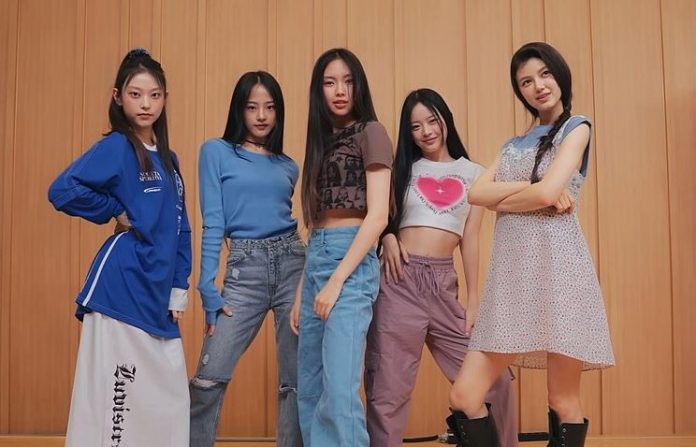 Members of the K-Pop group New Jeans strike a pose