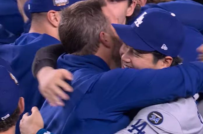 Shohei Ohtani embraces a teammate after winning the World Series title with the Dodgers