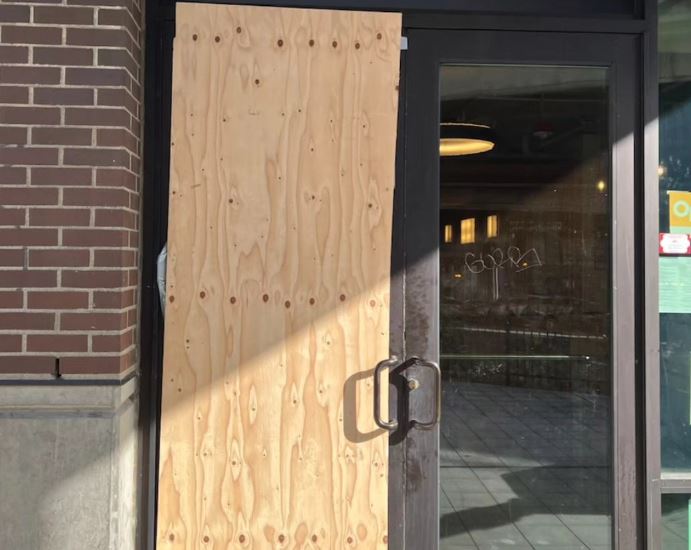 The entrance to Phnon Penh Noodle House is boarded up following a recent break-in.