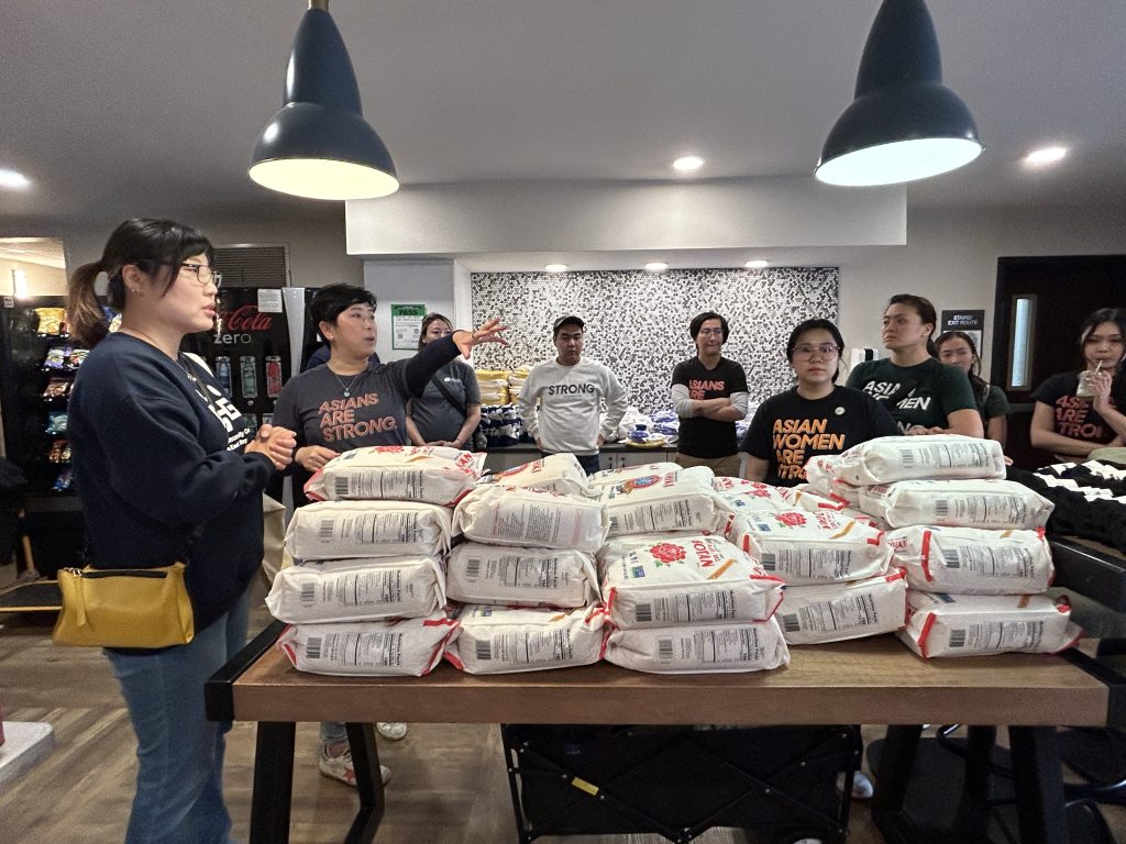  KCCEB's associate director Yeri Shon, left, and Asians Are Strong co-founder Zeien Cheung, second from left, coordinate volunteers before distribution of essential goods and in-kind donations to the displaced seniors being held in Alameda. 