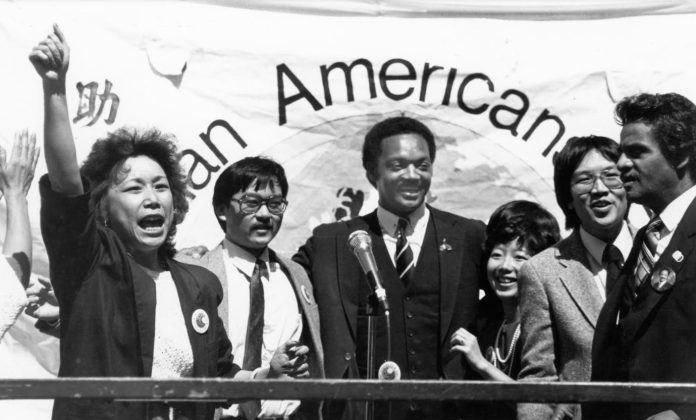 Eddie Wong. second on the right, standing between Rev. Howard Gloyd and Mabel Teng, former San Francisco City Assessor. On the left are Pam Tau Lee and Ken Kong of the Chinese Progressive Association with the Rev. Jesse Jackson in the middle.