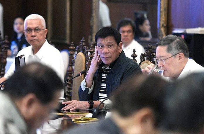 Rodrigo Duterte listens to members of the Cabinet during the second Cabinet meeting at the State Dining Room in Malacañan Palace