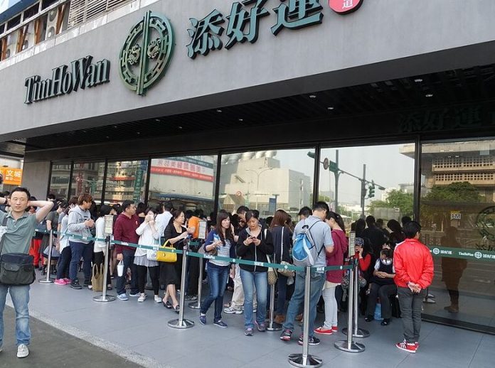 A crowd lines up to get inside popular Tim Ho Wan Restaurant