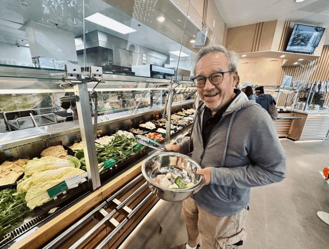 William Wong enjoys hot pot for the first time 