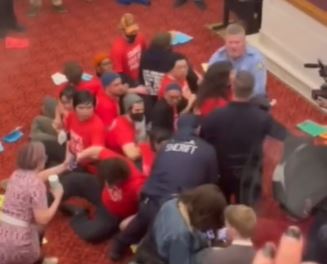 About a dozen protesters staged a sit in at the Philadelphia Council Chambers before police arrested them.