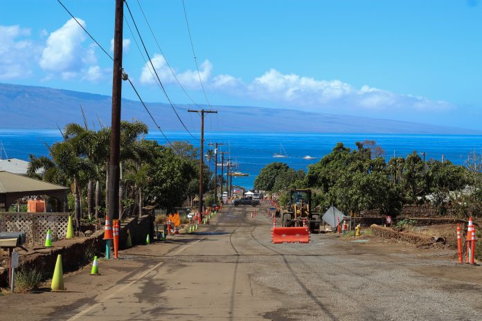 A picture of the Lahaina burn zone with waters in the back.