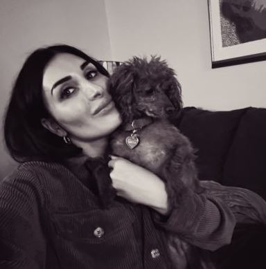 Laura Loomer is seen here cuddling a dog.