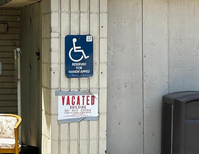 A vacated sign is plastered on the wall of the former Sakura Intermediate Care Facility.