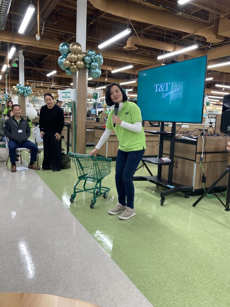 T&T's Tina Lee shows off the chain's shopping carts sized tor future shoppers-kids.