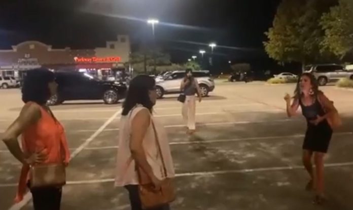 A woman is seen yelling at three women in Plano, TX in this screen shot from cell phone video of the incident